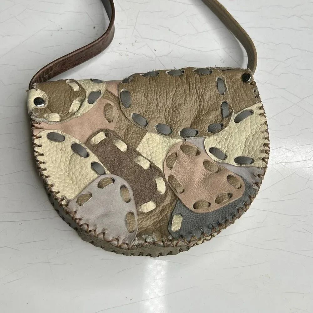 handmade, upcycled leather patchwork crossbody saddle bag with an adjustable str